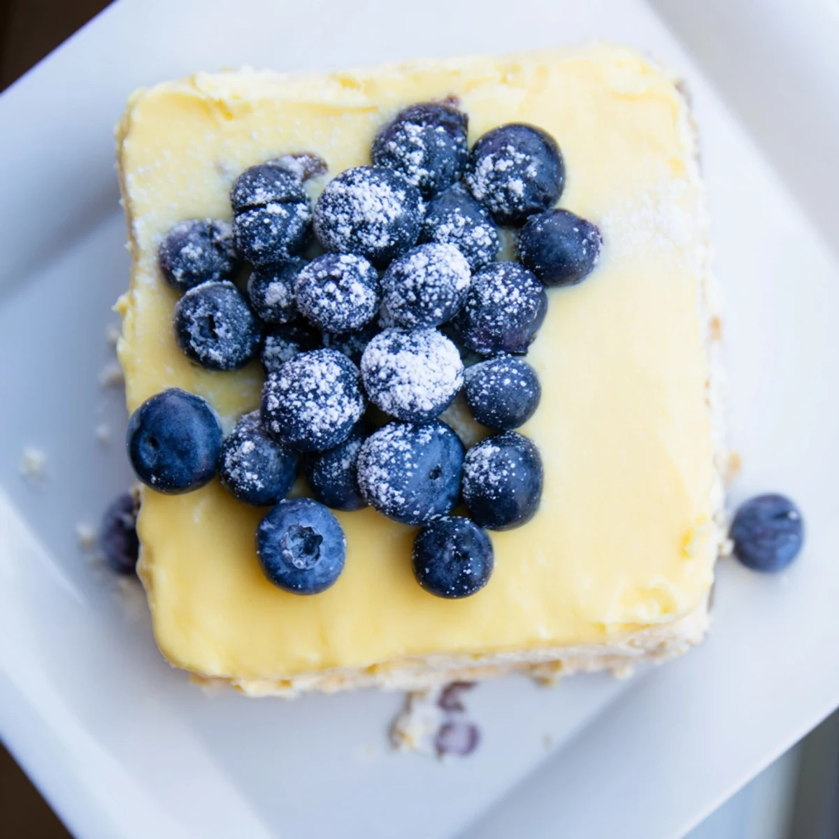 Golden-crusted Decadent Lemon Curd and Blueberry Squares, topped with vibrant, sweet blueberries, ready to eat.