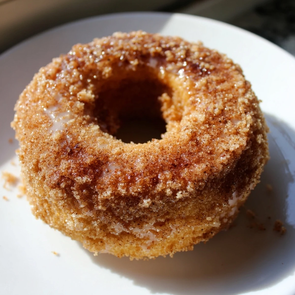 A close-up of golden brown cinnamon-sugar baked donuts with a sweet coating and inviting texture.