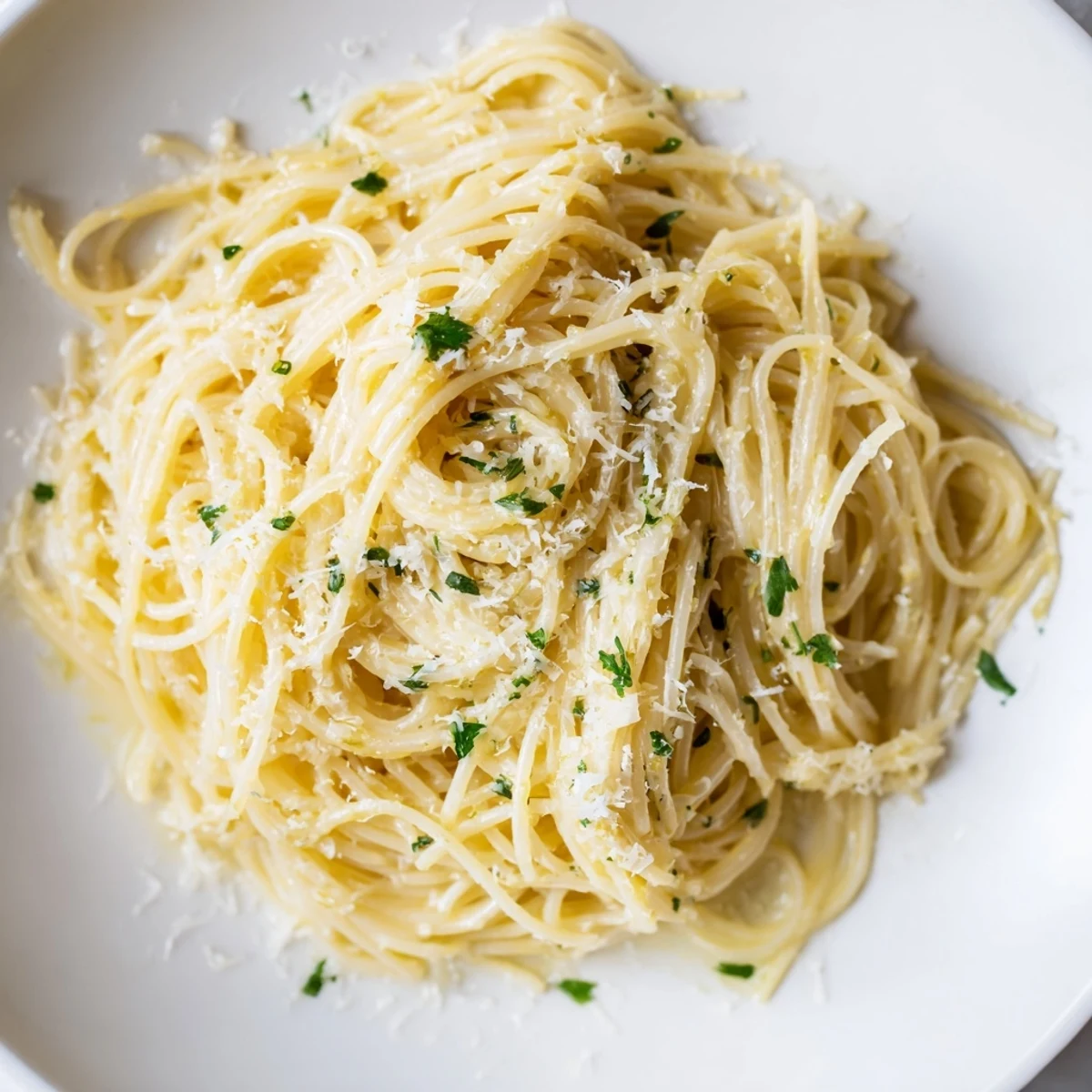 Fork-tossed Lemon Butter Pasta Light glistens on a plate, surrounded by lemon halves and fresh herbs for a zesty Italian meal.