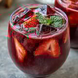 Vibrant strawberry açaí refresher with fresh fruit, green coffee extract, and a hint of lemon for a refreshing, energizing drink.