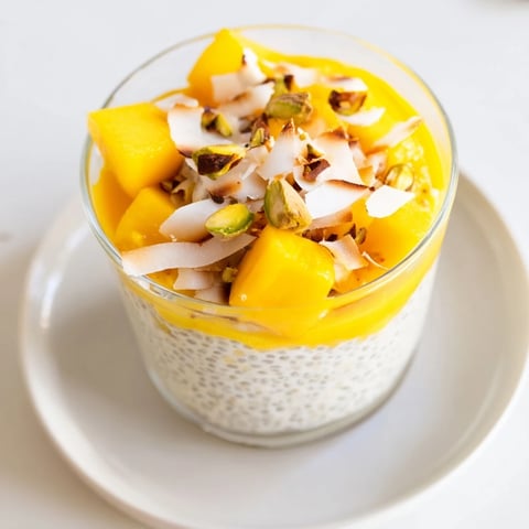 Creamy Mango Coconut Chia Pudding layered with fresh mango, ready to eat with toppings.