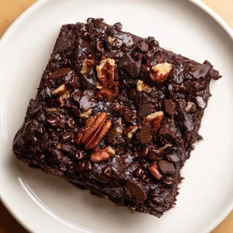 A plate of freshly baked Black Bean Brownies, dark and delicious, perfect for a gluten-free dessert.