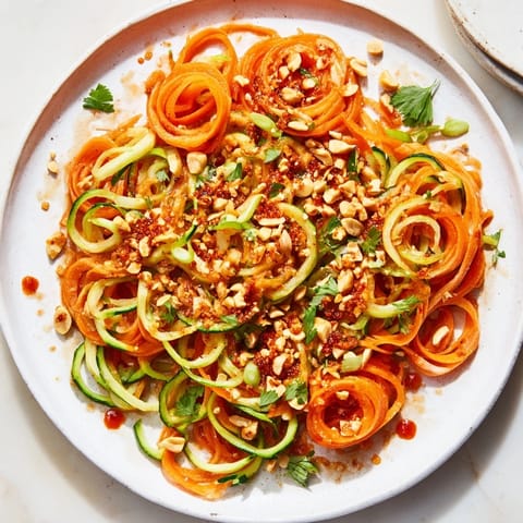 Fresh, crunchy Spicy Cucumber Noodle Bowl, ready to eat, with bright greens and a spicy kick.