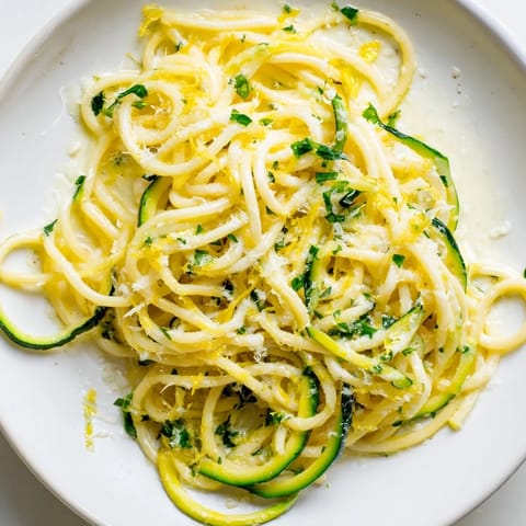 Al dente pasta is tossed with tender-crisp zucchini ribbons in a glossy lemon butter sauce, finished with Parmesan and parsley in this easy 30-minute Italian-inspired dish.