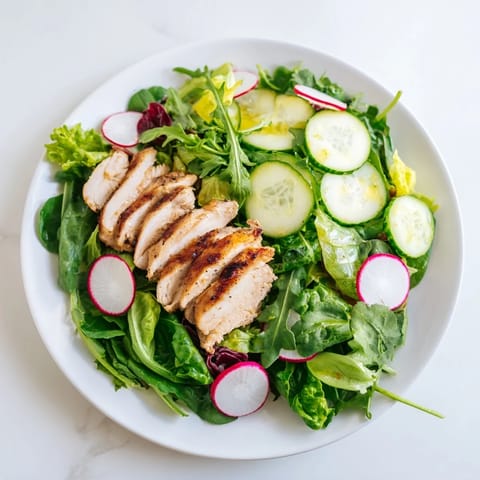 A bowl of Spring Detox Chicken Salad with tender grilled chicken and a zesty lemon vinaigrette.