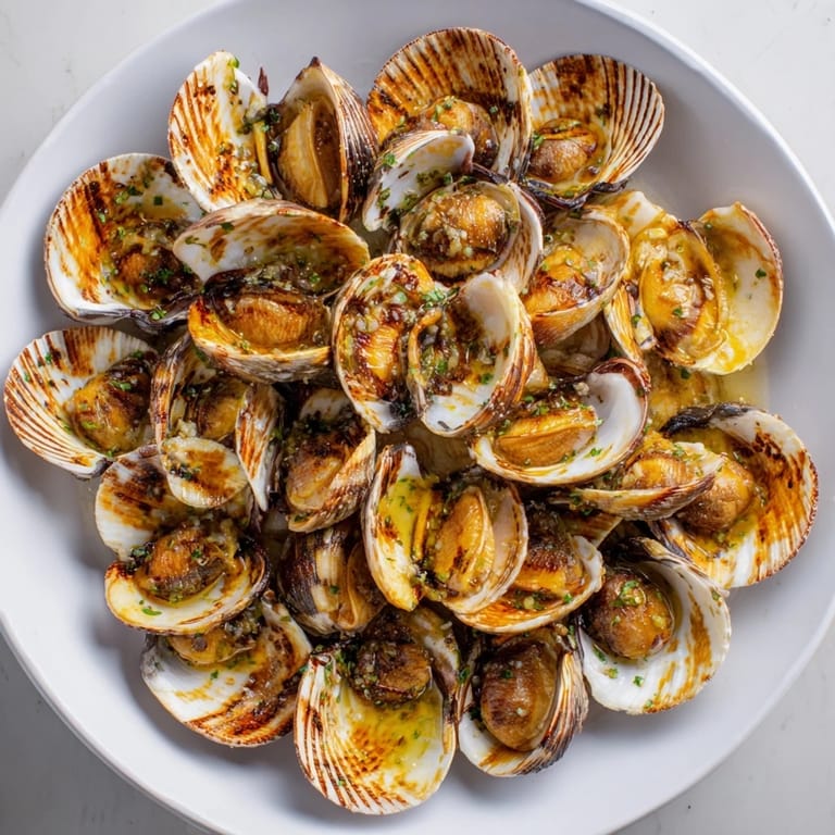Perfectly cooked, pan-seared scallops with a rich garlic butter sauce, ready for a delicious meal.