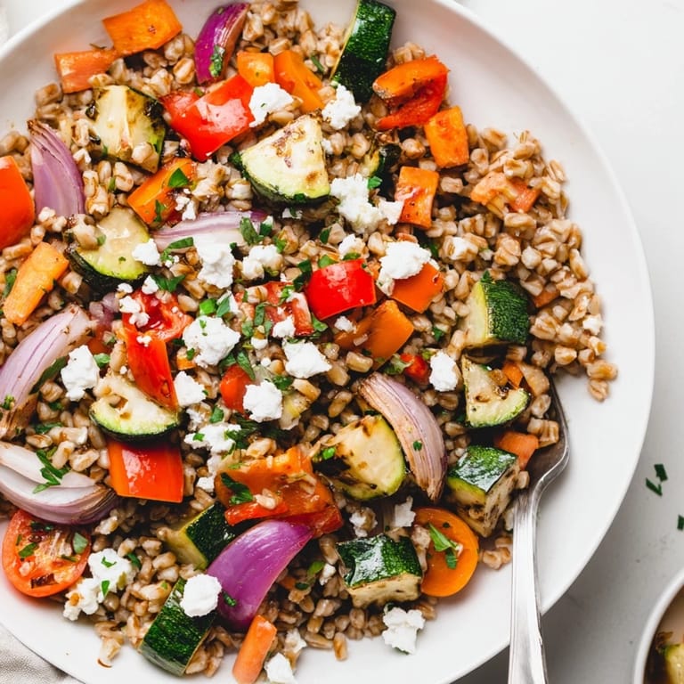 This hearty Mediterranean main dish features oven-roasted bell peppers, zucchini, and cherry tomatoes over nutty farro.