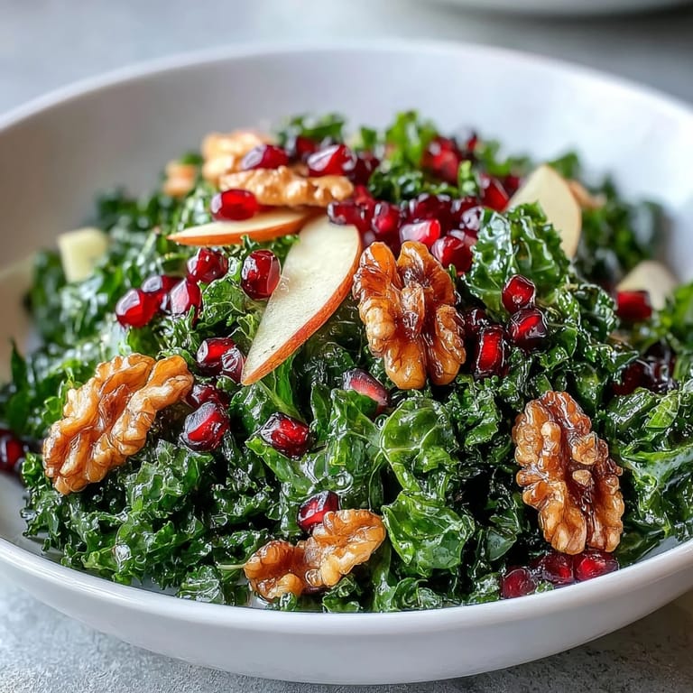 Healthy Kale and Pomegranate Bowl with crisp kale, bright pomegranate seeds, and sliced apples for a colorful salad.