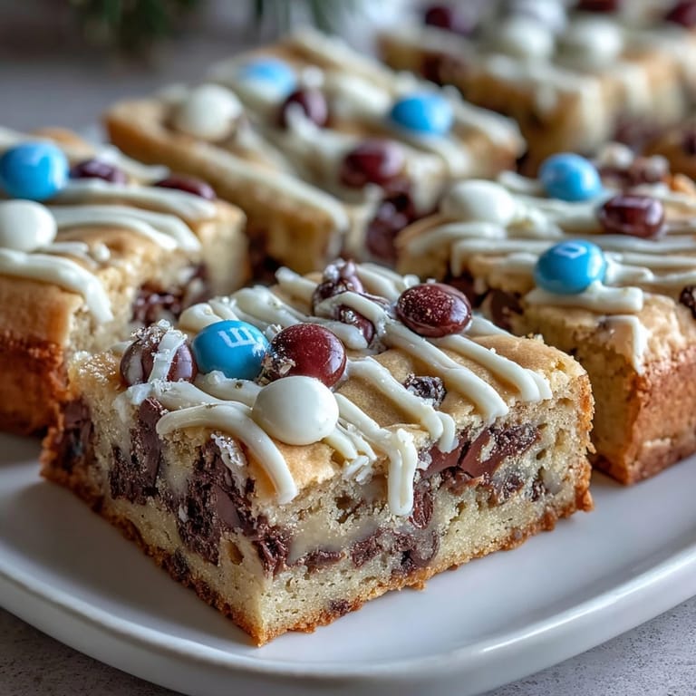 Festive cookie bars loaded with candy-coated chocolates, topped with creamy white chocolate drizzle for a graduation treat.