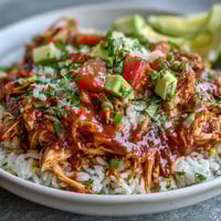 Colorful salsa chicken bowls with shredded chicken, rice, black beans, and fresh toppings in a vibrant, healthy dinner.