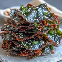 Crispy seaweed snack chips dusted with sesame seeds and sea salt, baked light.